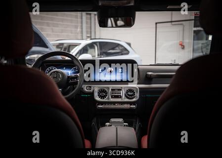 Interior of Mercedes AMG G Class with Red Leather Seats and Digital Display Stock Photo
