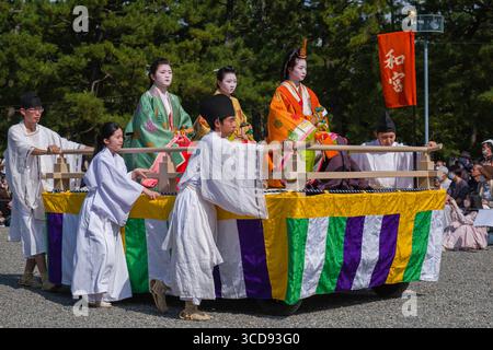 Imperial princess Kazu-no-Miya with distinctive women on wheeled cart ...