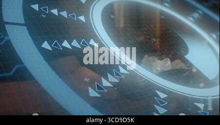 Showing circular interface overlaying office desk, with grid overlay, arrow icons and plus signs Stock Photo