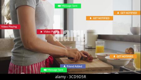 Woman in grey tee chopping vegetables using chef knife on board in kitchen, alerts, copy space Stock Photo