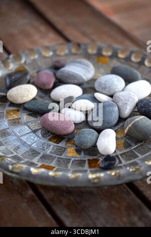 Small pebbles and stones on a glass plate Stock Photo