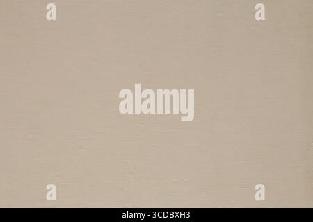 Beige background in small polka dots from smooth thick cardboard, close-up, light background for design uneven Stock Photo