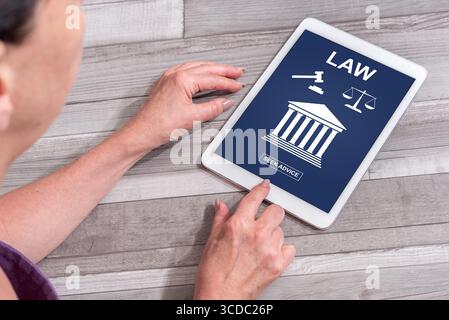 Woman using a tablet showing law concept Stock Photo