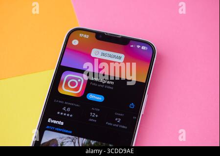 A Smartphone Shows The Popular Social Media Application Instagram Against A Colorful Background. Stock Photo