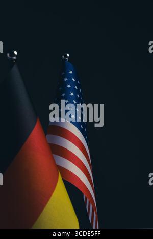 American and German flags on black background with copy space for text Stock Photo