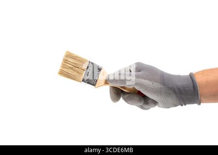 Hand in gloves holding paint brush. Isolated on white Stock Photo
