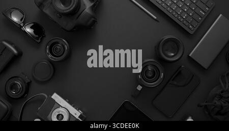 Photographer workspace concept. Various digital and analog gadgets placed on black background. Computer keyboard, digital camera, analog camera, phone Stock Photo