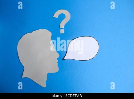 Human Head Silhouette with Blank Speech Bubble and Question Mark Stock Photo