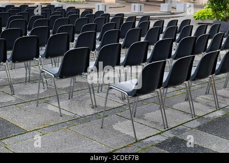 The open-air seating area, arranged with empty plastic chairs, reflects the calmness before the upcoming event. Stock Photo