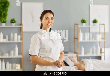 Cosmetologist and professional beautician before spa beauty treatment and therapy for female client Stock Photo