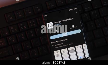Google NotebookLM app on a smartphone screen against a keyboard backdrop, with install button visible Stock Photo
