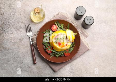 Tasty stuffed pattypan squash with tomatoes and arugula served on grey table, flat lay Stock Photo
