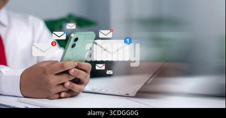 Email, contact, online communication, messaging, and business correspondence in a modern office. Close-up of businessman holding smartphone with digit Stock Photo