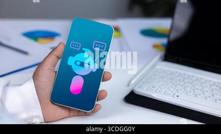 AI technology, virtual assistants, and digital customer service in a modern business environment. Close-up of hand holding smartphone with chatbot ico Stock Photo