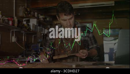 Measuring craftsman using pencil and metal ruler marking plank in workshop with stock chart overlay Stock Photo