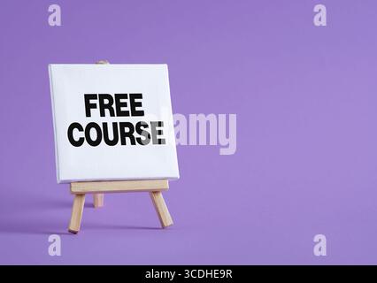 Small easel with white canvas showing free course text on purple background, great concept for online education Stock Photo