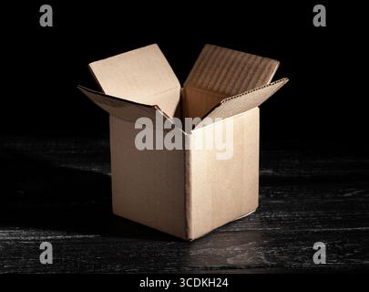 open carton box on black wood background Stock Photo