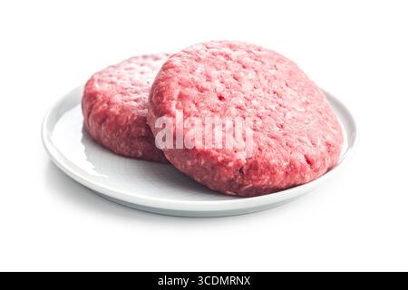 Raw burger beef patties on plate isolated on a white background. Stock Photo