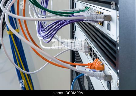 SFP+ 10 Gbps Direct Attach Cable plugged into 10GbE SFP+ port on a UniFi Switch Pro 24 PoE Stock Photo