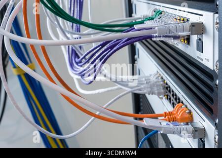 SFP+ 10 Gbps Direct Attach Cable plugged into 10GbE SFP+ port on a UniFi Switch Pro 24 PoE Stock Photo