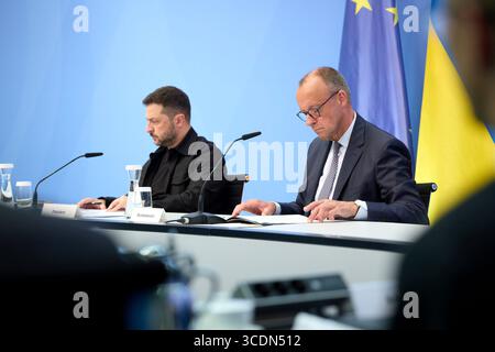 Berlin, Germany. 13th Aug, 2025. Ukrainian President Volodymyr Zelenskyy, left, and German Chancellor Friedrich Merz, right, listen during a virtual summit meeting at the Chancellery, August 13, 2025 in Berlin, Germany. The two leaders hosted a virtual summit with European leaders and U.S President Donald Trump to discuss the upcoming US-Russian Summit. Credit: Pool Photo/Ukrainian Presidential Press Office/Alamy Live News Stock Photo