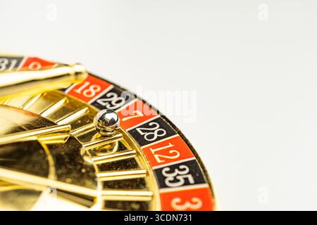 Image of a casino roulette wheel with vibrant gold trim, rich red numbers on white felt, featuring alternating black and red numbers from 1 to 36, sin Stock Photo