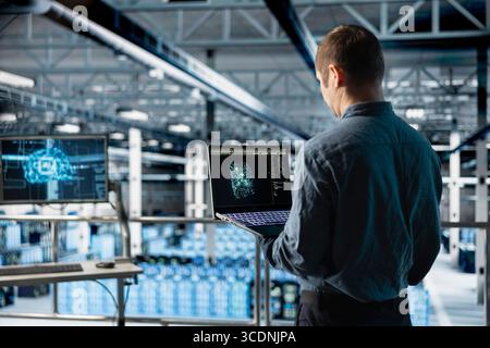 Data center IT specialist monitoring AI LLM visualization output to verify inference patterns. Programmer analyzing neural language network structure in server room using laptop Stock Photo