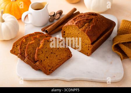 Pumpkin bread freshly baked sliced on a serving board, Thanksgiving dessert idea Stock Photo