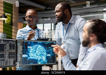 Team of traders doing brainstorming in office, using AI LLM for stock exchange analysis. Teamworking prop firm colleagues integrating machine learning analytics to monitor stock market Stock Photo