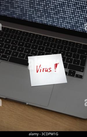Virus, warning sign, laptop infected. Virus, warning sign, laptop infected. Binary code, bits and bytes. Note, message, cyber attack, threat, network security, hacked, computer crime. technology computer virus B97A8626 Stock Photo