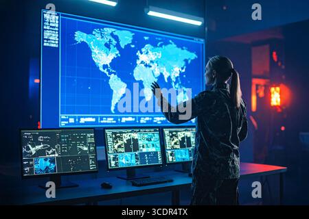 One of the series of photos : Military Analyst looking at large map screens with Stock Photo