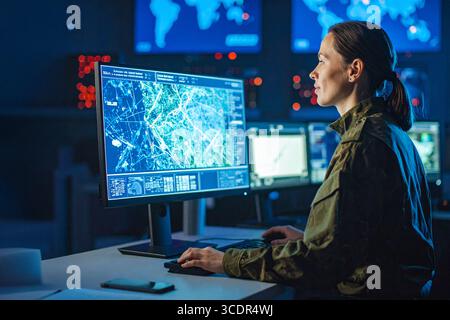 One of the series of photos : Military Analyst looking at large map screens with Stock Photo