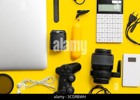 Composition with modern gadgets on yellow background Stock Photo