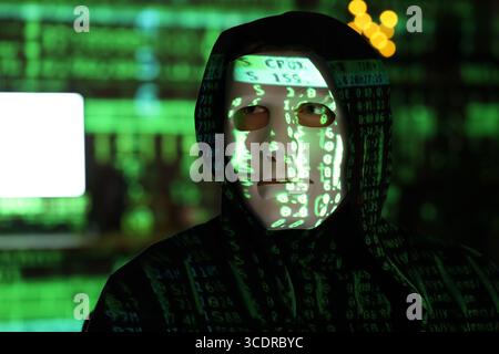 Hacker and projection of programming code in dark room, closeup Stock Photo