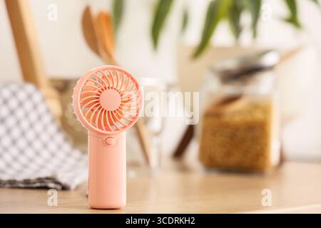Mini fan on counter in kitchen, closeup Stock Photo