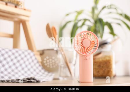 Mini fan on counter in kitchen, closeup Stock Photo