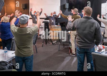 People raising their hands in prayer to Jesus at the conclusion of the 3DM Learning Community Immersion, Iglesia La Jornada Covenant Church, 3525 Ches Stock Photo