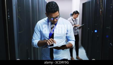 Inspection, maintenance and tablet with man in server room for cybersecurity support. App, database and mainframe with IT professional people in Stock Photo