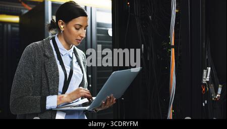 Inspection, technical support and woman with laptop in control room for maintenance in office. Computer, database and IT consultant at board system Stock Photo