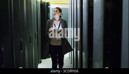 Database, inspection and tech support with woman in server room for cybersecurity or maintenance. App, infrastructure and mainframe with IT Stock Photo