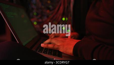 Night, hands and man on laptop for hacking, programming or cybersecurity website. Software attack, late or hacker typing in dark room for big data Stock Photo
