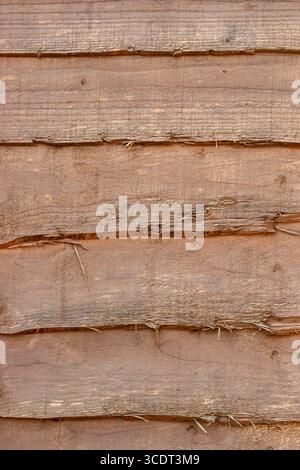 Brown natural rustic wooden fence panel background backdrop. Garden boundary structure concept. Stock Photo