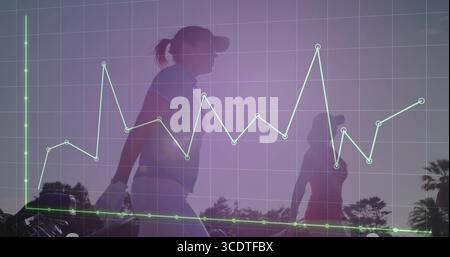 Two female golfers wearing polos and caps walking along golf fairway, with data grid overlay Stock Photo