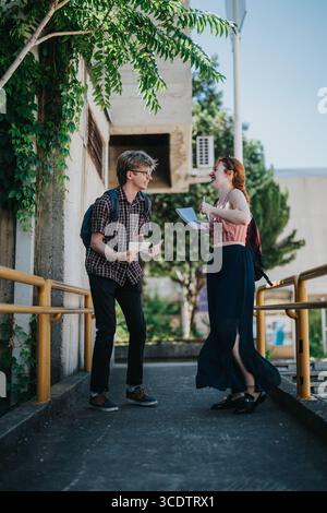 Students interacting and having a conversation in a school courtyard setting Stock Photo