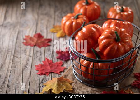 autumn pumpkins background on rustic wooden background with autumn leaves Stock Photo