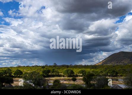 Cumulus clouds gather in size and strength and result in a localised shower. If the clouds continue to tower they can result in Cumulonimbus forming Stock Photo