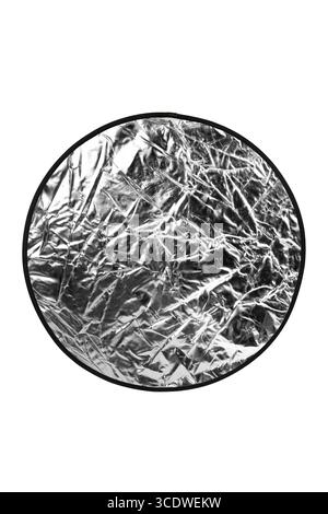 Close-up of a silver photography reflector's shiny, crinkled surface. Stock Photo