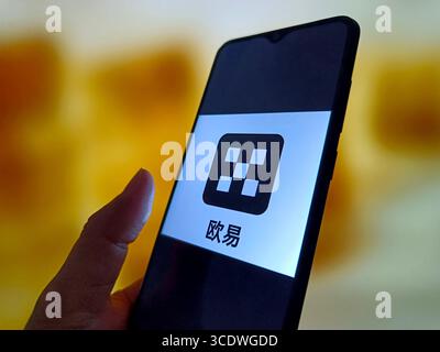 SUQIAN, CHINA - AUGUST 14, 2025 - A illustration photo shows OKX logo displayed in a smartphone in Suqian, Jiangsu Province, China on August 14, 2025. Stock Photo