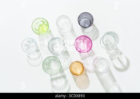 Drinking glasses on white background top view. Colored glass. Stock Photo