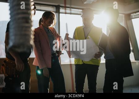 Construction Professionals Collaborating at a Building Site During Daylight Stock Photo